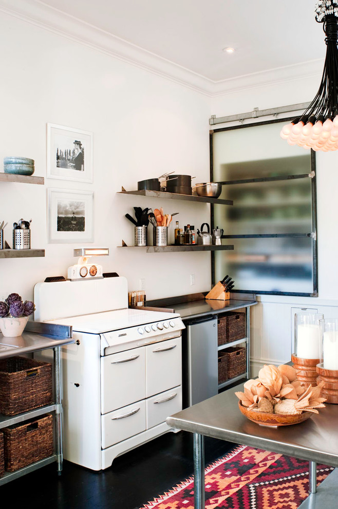 Inspiration for a medium sized contemporary single-wall enclosed kitchen in San Francisco with open cabinets, white appliances, a submerged sink, stainless steel cabinets, stainless steel worktops, white splashback, dark hardwood flooring and an island.