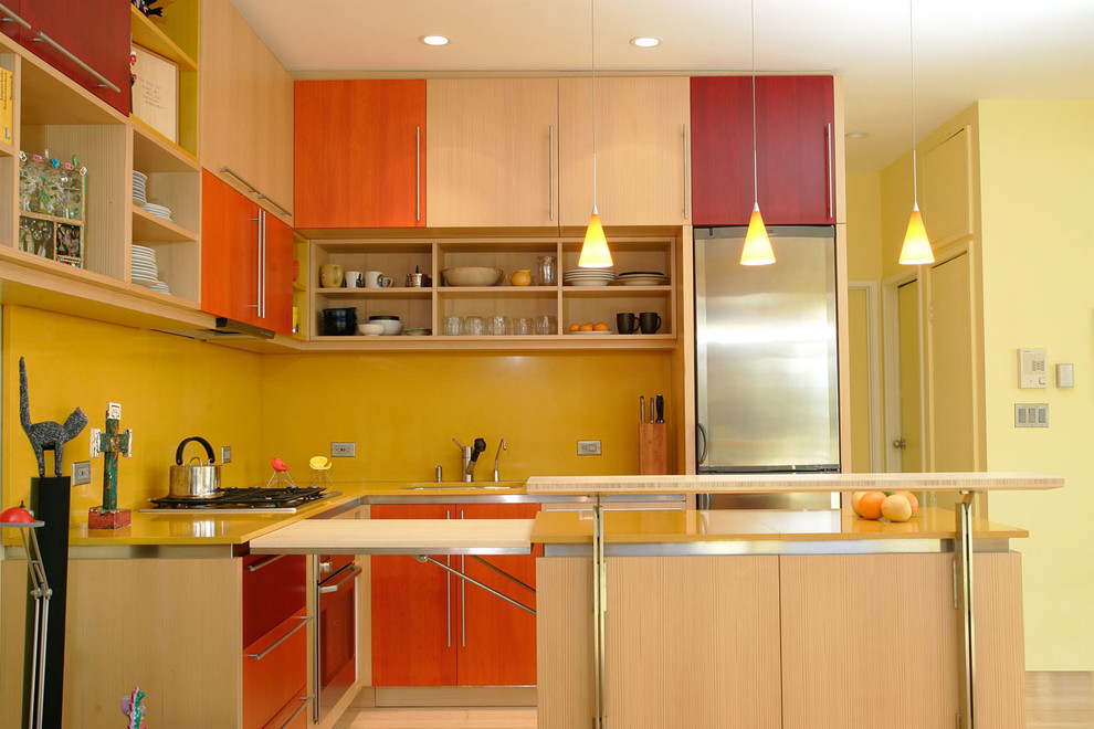 Example of a small minimalist u-shaped bamboo floor open concept kitchen design in San Francisco with an undermount sink, quartz countertops, yellow backsplash, stone slab backsplash, stainless steel appliances and an island