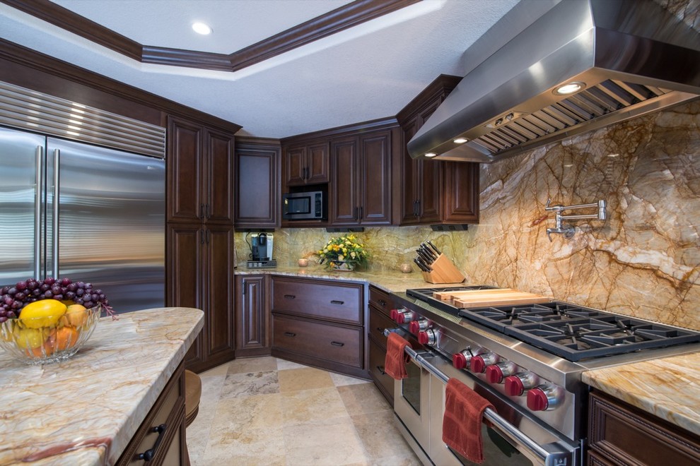 Inspiration for a timeless u-shaped eat-in kitchen remodel in San Diego with a drop-in sink, raised-panel cabinets, dark wood cabinets, granite countertops, multicolored backsplash, stone slab backsplash and stainless steel appliances