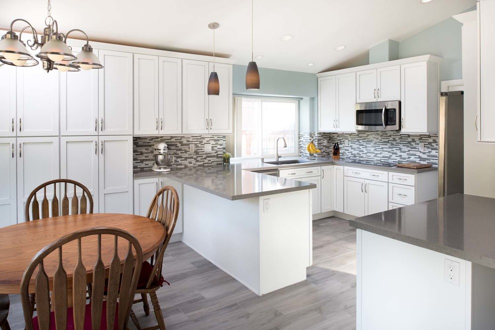 Mid-sized trendy u-shaped porcelain tile eat-in kitchen photo in San Diego with an undermount sink, shaker cabinets, white cabinets, quartz countertops, multicolored backsplash, mosaic tile backsplash, stainless steel appliances and a peninsula