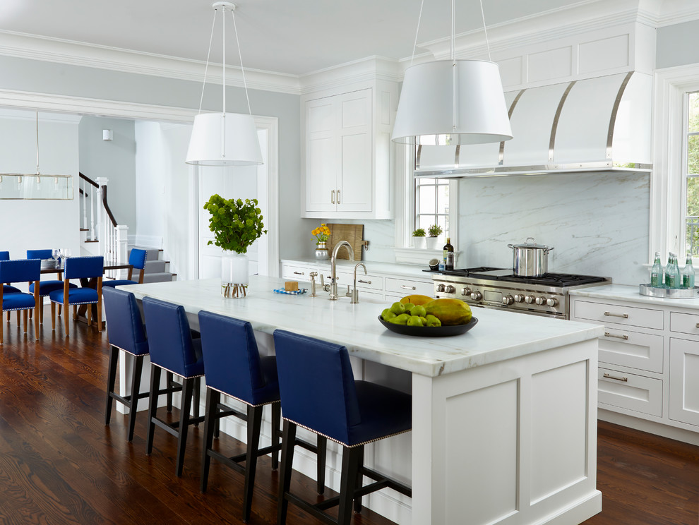 Inspiration for a large transitional medium tone wood floor and brown floor kitchen remodel in New York with shaker cabinets, white cabinets, marble countertops, white backsplash, marble backsplash, stainless steel appliances and an island