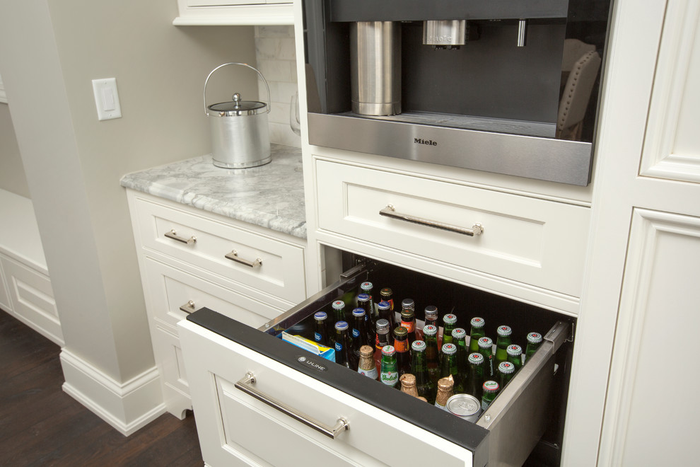 Expansive classic u-shaped kitchen in Columbus with a belfast sink, beaded cabinets, white cabinets, granite worktops, integrated appliances, dark hardwood flooring and an island.