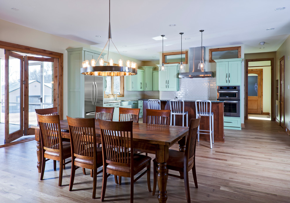 Large trendy l-shaped light wood floor eat-in kitchen photo in Charlotte with a farmhouse sink and an island