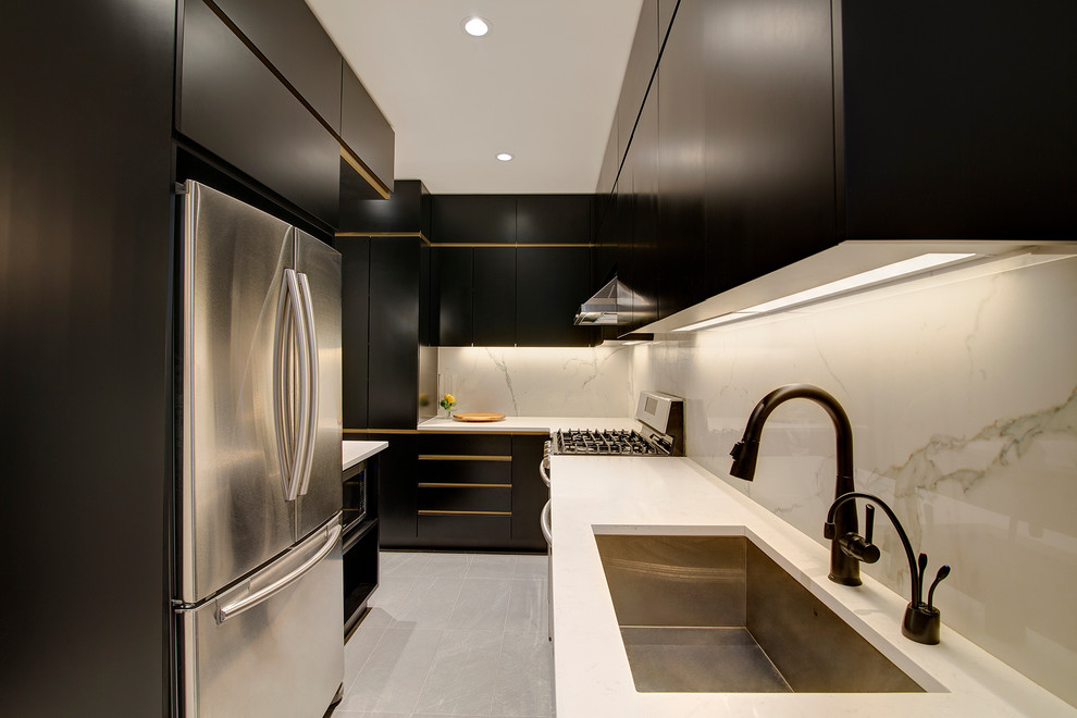 Enclosed kitchen - mid-sized contemporary l-shaped porcelain tile enclosed kitchen idea in New York with an undermount sink, flat-panel cabinets, black cabinets, quartz countertops, white backsplash, porcelain backsplash and black appliances