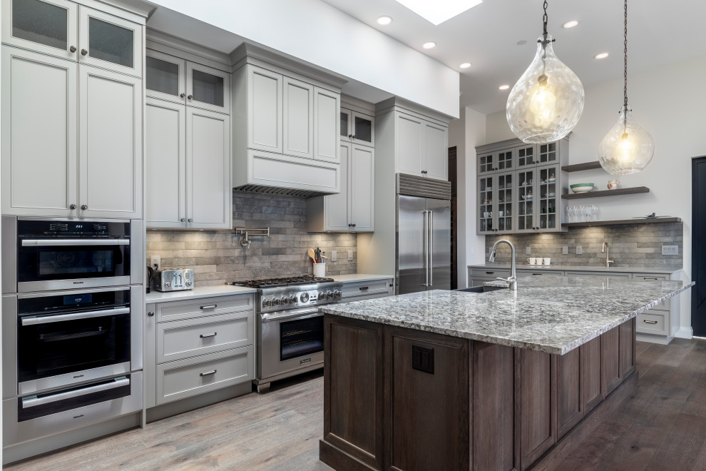 Large elegant eat-in kitchen photo in Vancouver with recessed-panel cabinets, gray cabinets, granite countertops, stainless steel appliances and an island