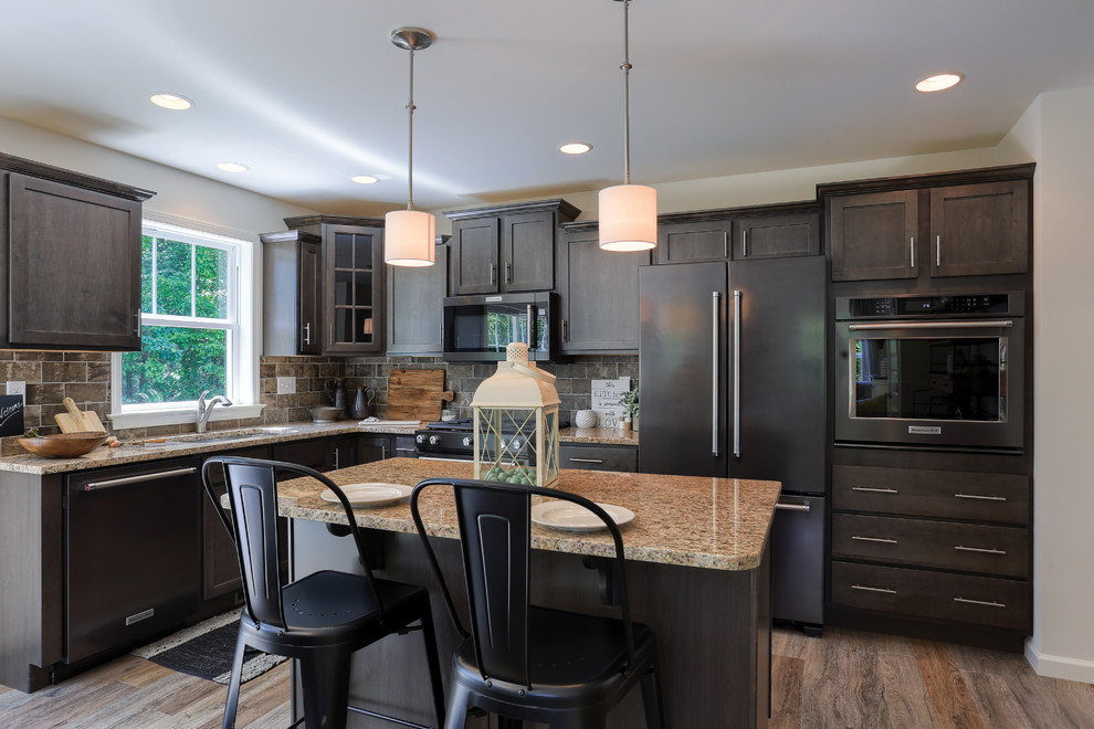 Open concept kitchen - mid-sized transitional l-shaped medium tone wood floor and brown floor open concept kitchen idea in Other with recessed-panel cabinets, dark wood cabinets, granite countertops, gray backsplash, stainless steel appliances and an island
