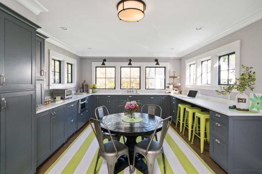 Transitional u-shaped medium tone wood floor and brown floor kitchen photo in Boston with shaker cabinets, gray cabinets, stainless steel appliances and no island