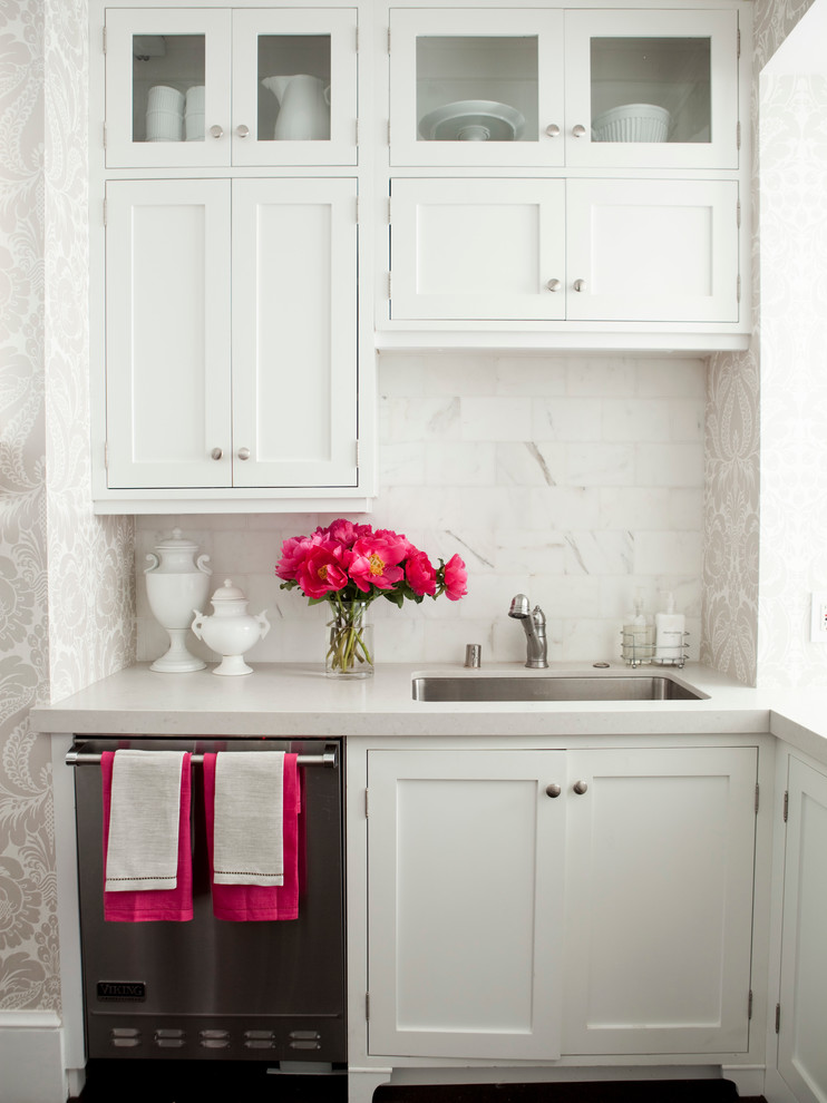 Inspiration for a timeless kitchen remodel in San Francisco with shaker cabinets, stainless steel appliances, a single-bowl sink, white cabinets, white backsplash and stone tile backsplash