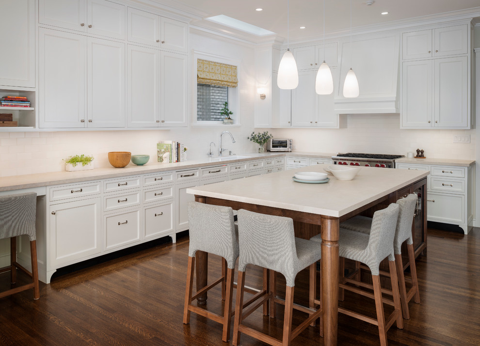 Traditional l-shaped kitchen in San Francisco with shaker cabinets, white cabinets, white splashback and metro tiled splashback.