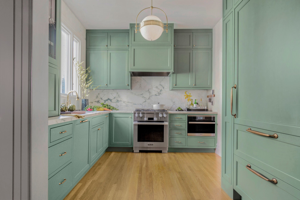 Example of a small transitional u-shaped light wood floor and beige floor enclosed kitchen design in San Francisco with marble countertops, marble backsplash, no island, white countertops, shaker cabinets, green cabinets, white backsplash and stainless steel appliances