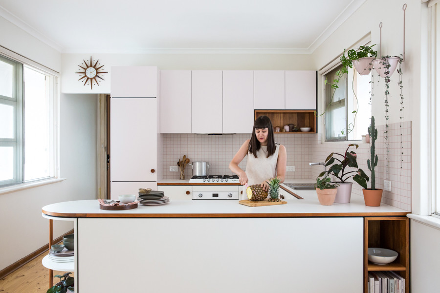 Inspiration for a small 1960s u-shaped light wood floor open concept kitchen remodel in Adelaide with flat-panel cabinets, laminate countertops, white backsplash, ceramic backsplash and white appliances