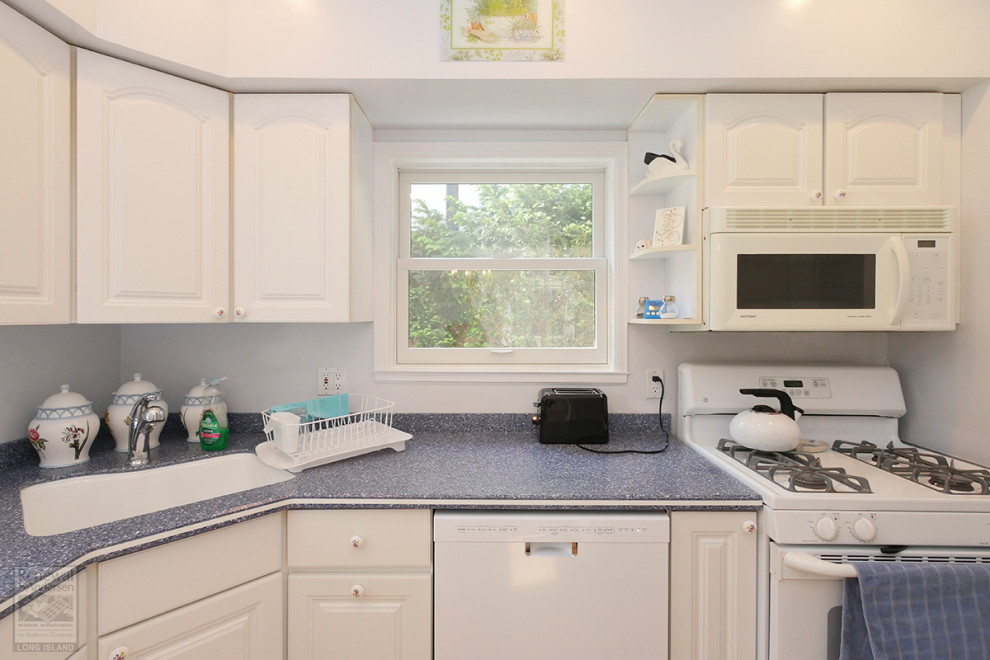 Enclosed kitchen - mid-sized l-shaped enclosed kitchen idea in New York with an undermount sink, white cabinets, blue backsplash, white appliances and blue countertops