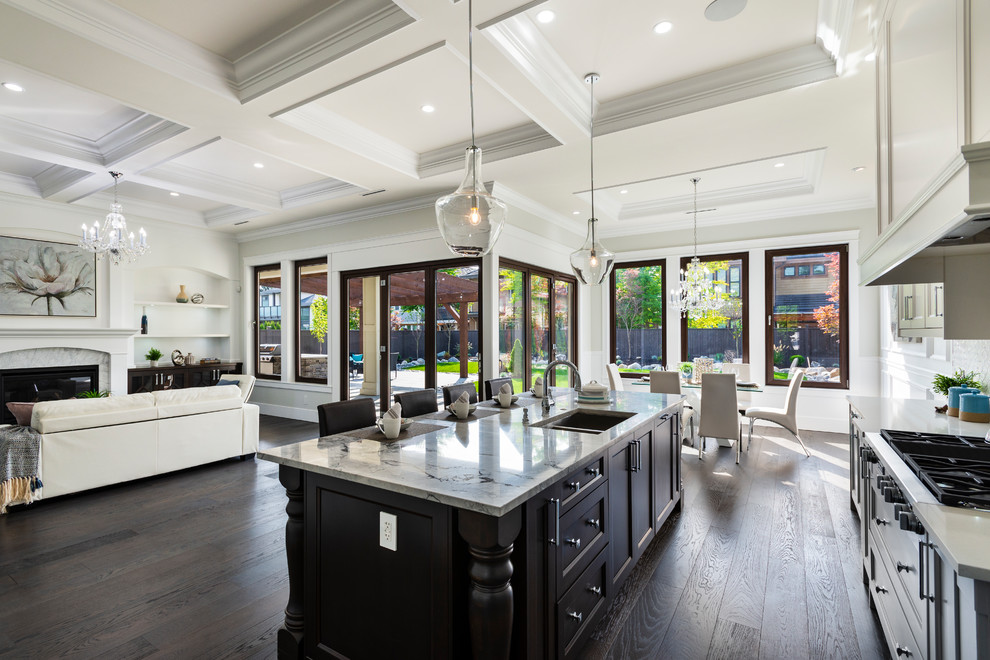 Huge elegant l-shaped dark wood floor and black floor open concept kitchen photo in Vancouver with an undermount sink, recessed-panel cabinets, dark wood cabinets, granite countertops, white backsplash, porcelain backsplash, stainless steel appliances, an island and gray countertops