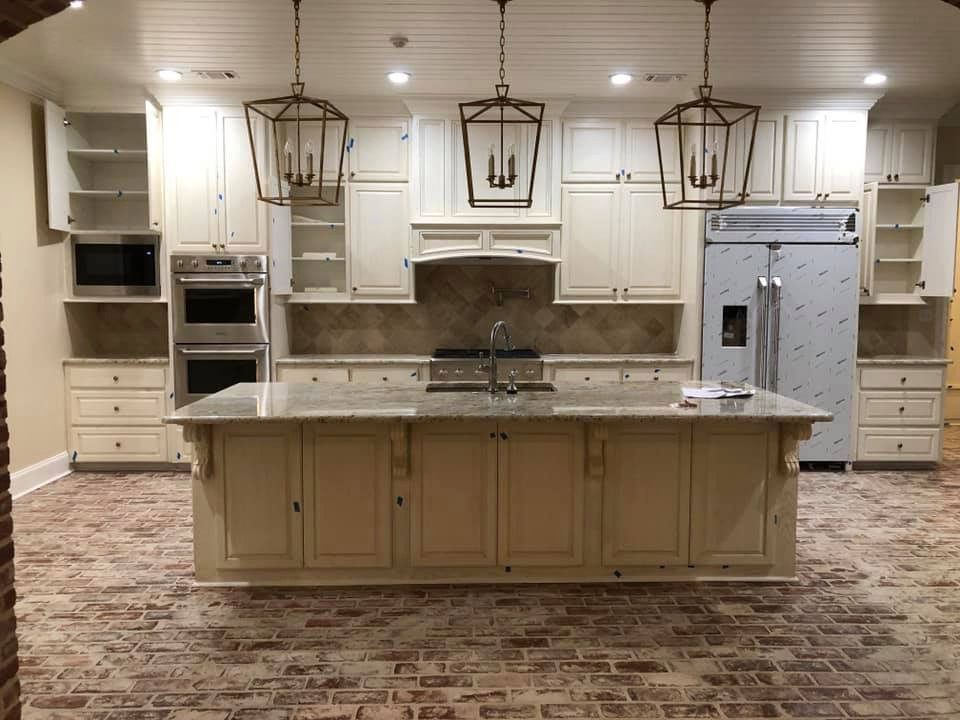 Inspiration for a huge french country single-wall brick floor, multicolored floor and wood ceiling open concept kitchen remodel in Other with an undermount sink, raised-panel cabinets, white cabinets, granite countertops, multicolored backsplash, ceramic backsplash, stainless steel appliances, an island and multicolored countertops