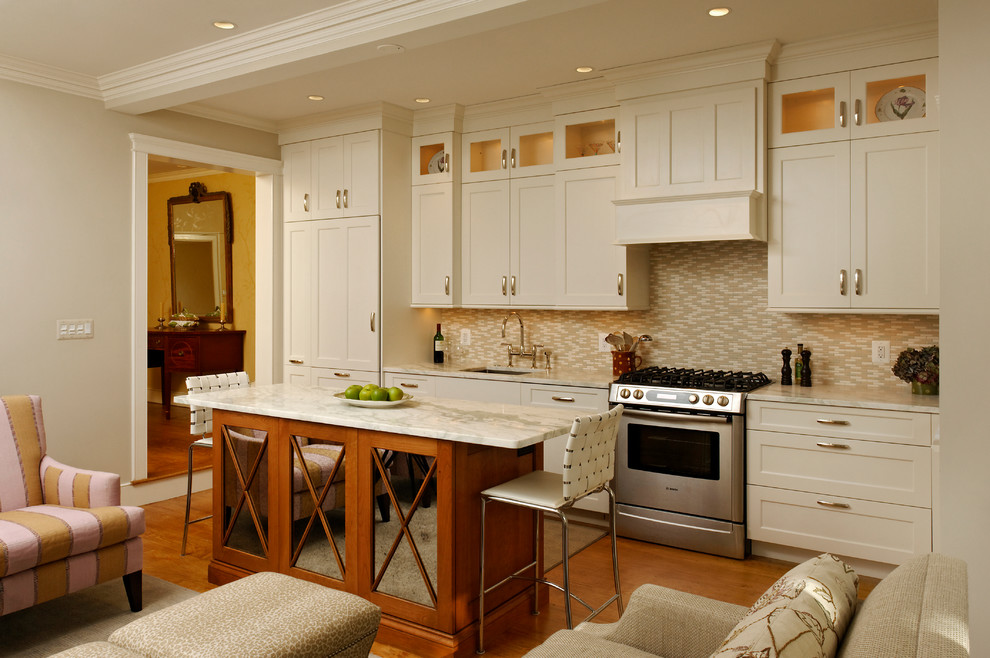 Example of a classic single-wall open concept kitchen design in DC Metro with recessed-panel cabinets, white cabinets, marble countertops, beige backsplash, matchstick tile backsplash and paneled appliances