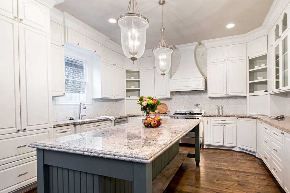 Inspiration for a mid-sized timeless u-shaped medium tone wood floor open concept kitchen remodel in Denver with an undermount sink, raised-panel cabinets, white cabinets, granite countertops, gray backsplash, mosaic tile backsplash, stainless steel appliances and an island