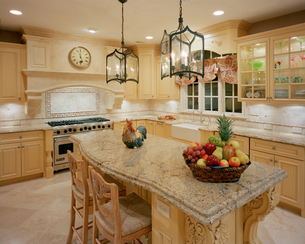 Inspiration for a timeless l-shaped eat-in kitchen remodel in New York with a farmhouse sink, raised-panel cabinets, yellow cabinets, granite countertops, beige backsplash, stone tile backsplash and stainless steel appliances