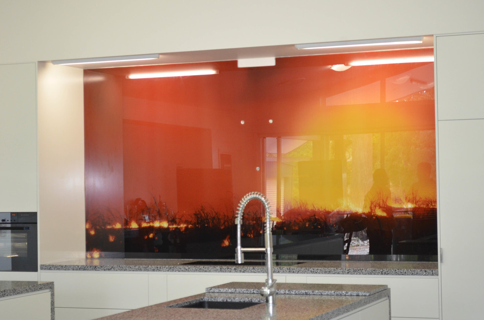 Contemporary kitchen in Brisbane with glass sheet splashback.