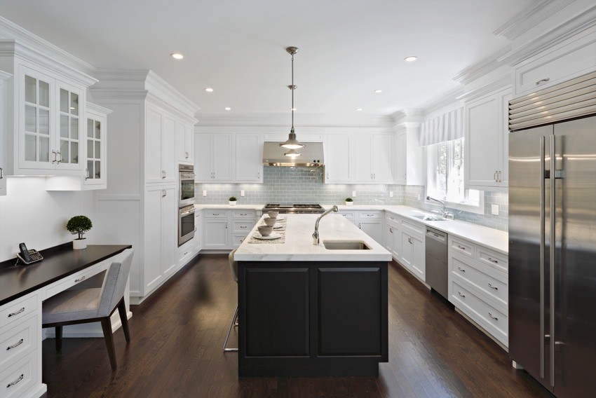 Transitional u-shaped dark wood floor eat-in kitchen photo in New York with a double-bowl sink, shaker cabinets, white cabinets, marble countertops, blue backsplash, glass tile backsplash, stainless steel appliances and an island