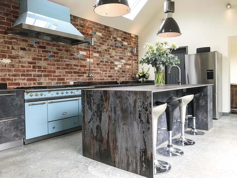 Inspiration for an urban kitchen in Other with flat-panel cabinets, black cabinets, concrete worktops, brick splashback, concrete flooring and grey floors.