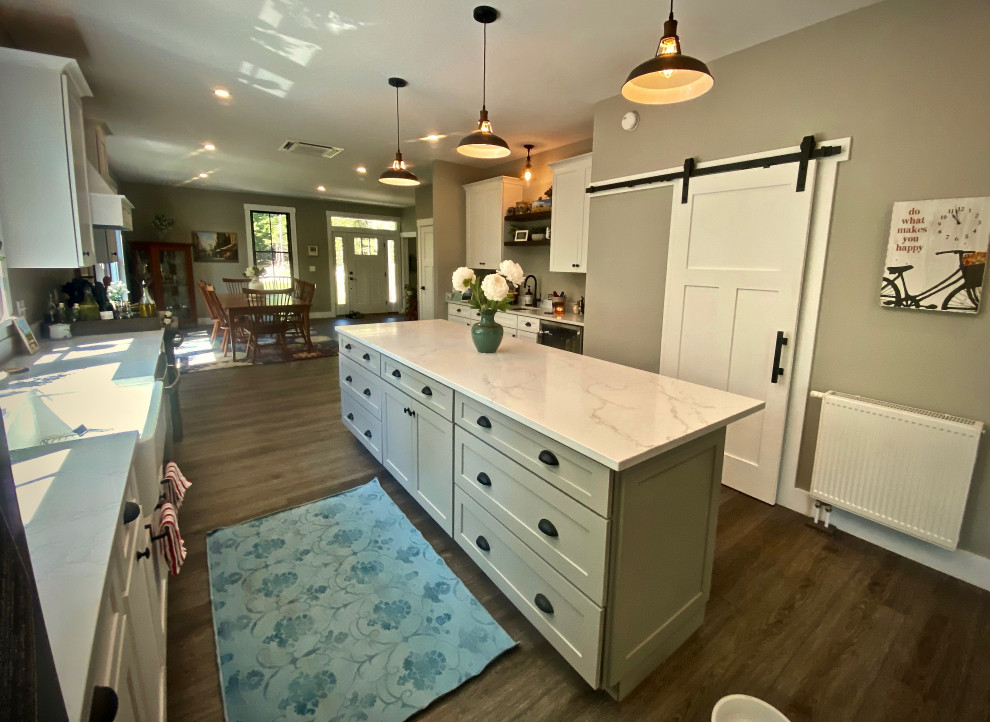 Example of a huge country galley vinyl floor and gray floor eat-in kitchen design in Portland Maine with a farmhouse sink, shaker cabinets, white cabinets, quartzite countertops, white backsplash, marble backsplash, stainless steel appliances, an island and white countertops