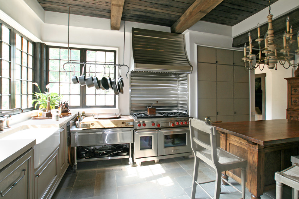 This is an example of a traditional kitchen in Charlotte with stainless steel appliances and a belfast sink.