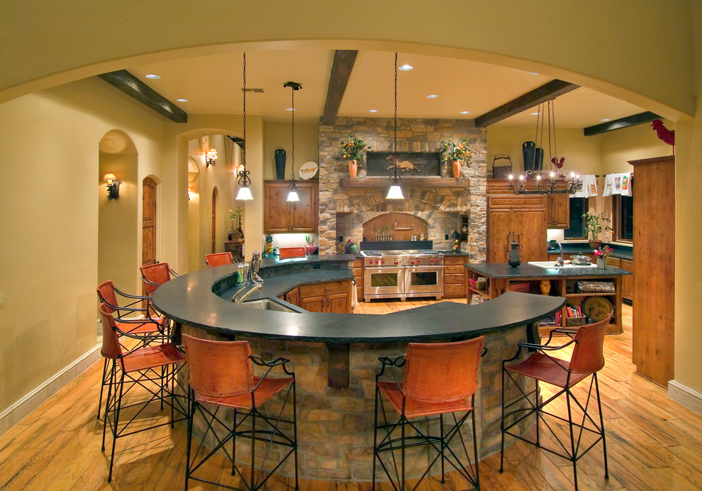 Photo of a mediterranean kitchen in Sacramento with a submerged sink, raised-panel cabinets and medium wood cabinets.