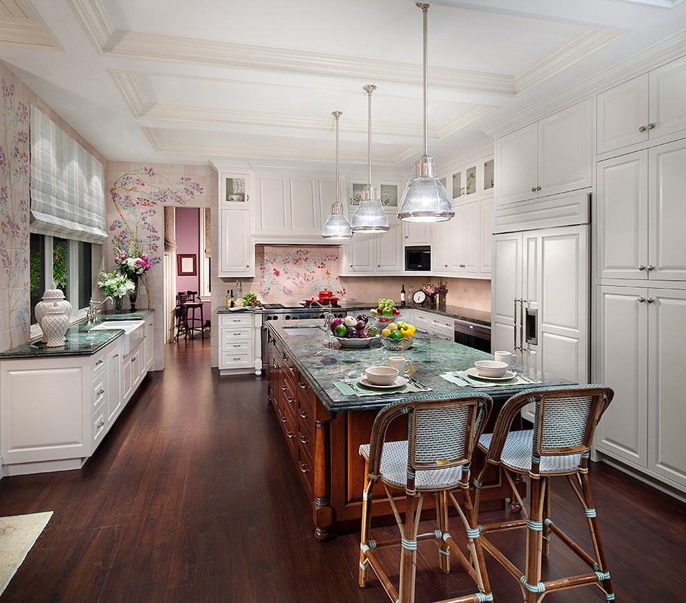 Inspiration for a large traditional u-shaped kitchen/diner in Miami with a double-bowl sink, raised-panel cabinets, white cabinets, stainless steel appliances, dark hardwood flooring, an island, quartz worktops, pink splashback, cement tile splashback and brown floors.