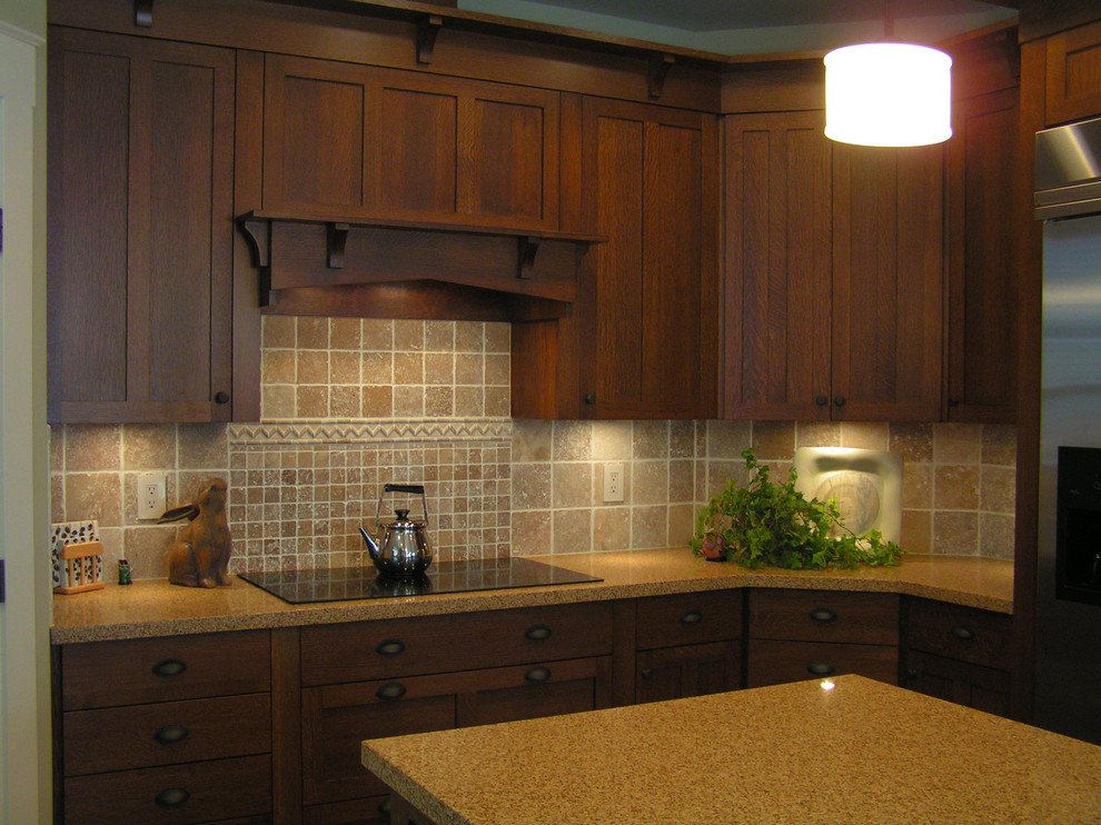 Example of a large classic l-shaped ceramic tile eat-in kitchen design in Vancouver with an undermount sink, recessed-panel cabinets, dark wood cabinets, quartz countertops, brown backsplash, stone tile backsplash, stainless steel appliances and an island