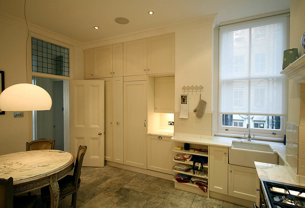 Exempel på ett litet eklektiskt kök, med en rustik diskho, skåp i shakerstil, vita skåp, marmorbänkskiva, vitt stänkskydd, stänkskydd i keramik, rostfria vitvaror och travertin golv