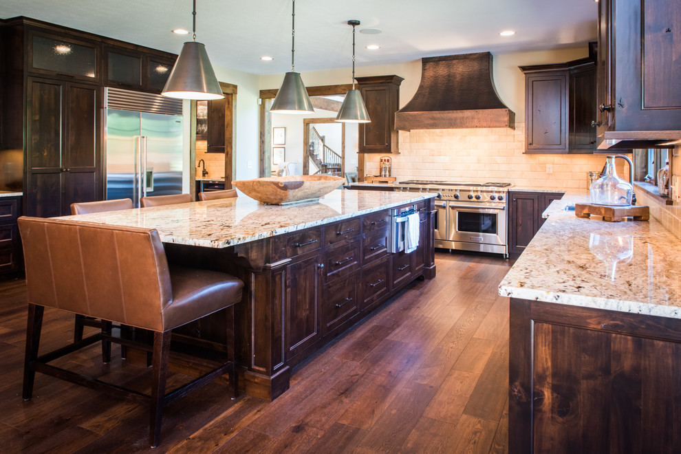 Large mountain style u-shaped dark wood floor eat-in kitchen photo in Cleveland with an undermount sink, beaded inset cabinets, dark wood cabinets, granite countertops, beige backsplash, stone tile backsplash, stainless steel appliances and an island