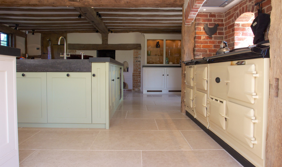 Photo of a country kitchen in Wiltshire with limestone flooring.