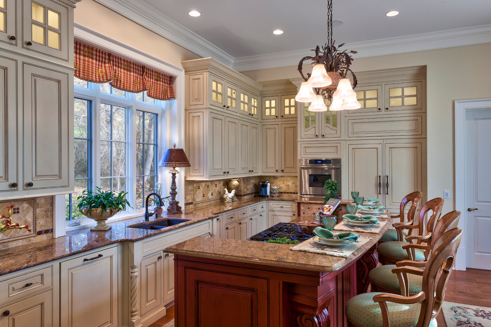 Example of a mid-sized classic galley medium tone wood floor eat-in kitchen design in Other with an undermount sink, raised-panel cabinets, white cabinets, granite countertops, black backsplash, stone tile backsplash and stainless steel appliances