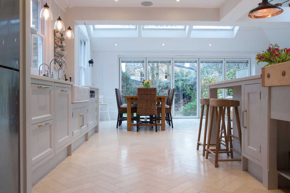 Inspiration for a modern kitchen in London with limestone flooring.
