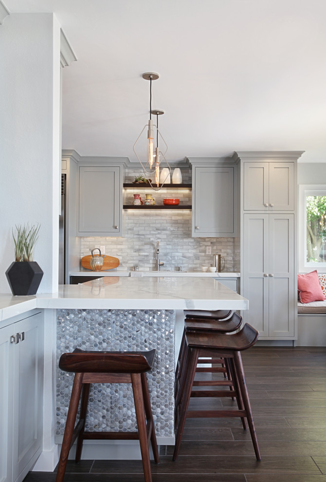 Inspiration for a large transitional u-shaped brown floor eat-in kitchen remodel in Orange County with shaker cabinets, gray cabinets, gray backsplash, a peninsula and gray countertops