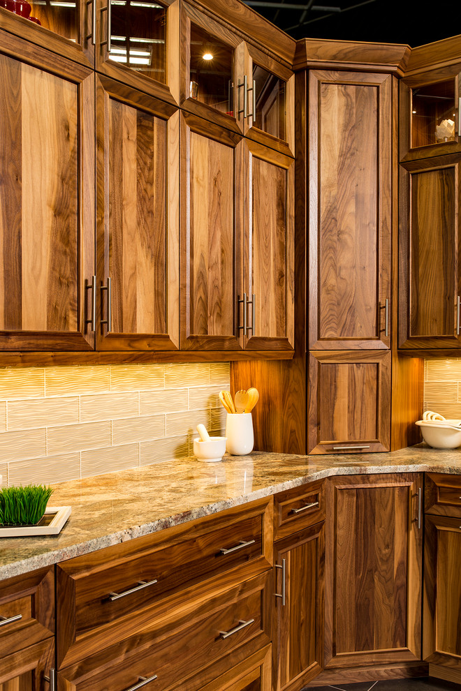 Medium sized classic l-shaped enclosed kitchen in Denver with a submerged sink, recessed-panel cabinets, medium wood cabinets, granite worktops, beige splashback, glass tiled splashback, slate flooring and grey floors.