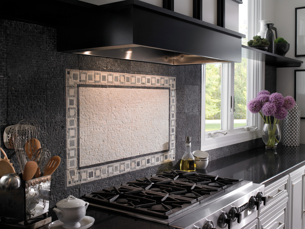 Eclectic kitchen in Cleveland with raised-panel cabinets, white cabinets, composite countertops, black splashback, stone tiled splashback, stainless steel appliances and black worktops.