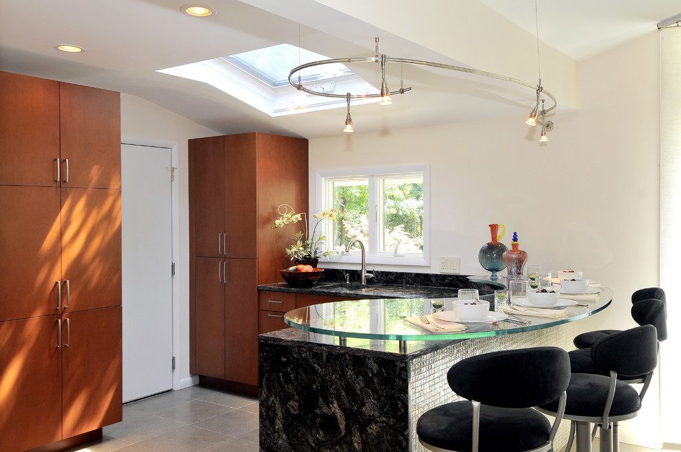 Photo of a medium sized contemporary l-shaped kitchen in New York with a submerged sink, flat-panel cabinets, medium wood cabinets, glass worktops, integrated appliances, porcelain flooring, a breakfast bar and brown floors.