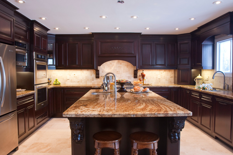 Inspiration for a timeless u-shaped eat-in kitchen remodel in Toronto with an undermount sink, raised-panel cabinets, brown cabinets, stainless steel appliances and an island
