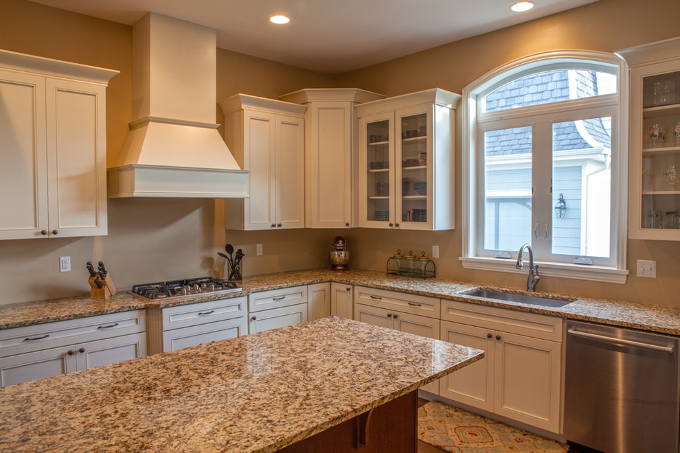 Inspiration for a medium sized traditional l-shaped enclosed kitchen in Denver with a submerged sink, recessed-panel cabinets, white cabinets, granite worktops, stainless steel appliances, an island, brown floors and medium hardwood flooring.