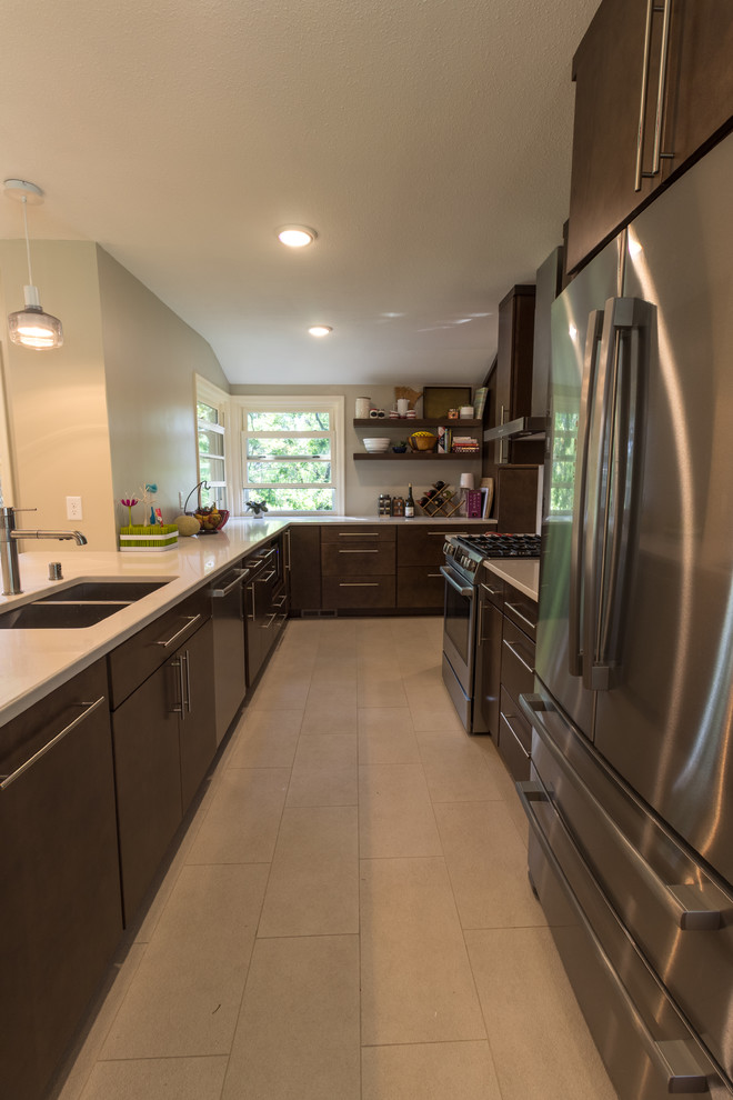Retro open plan kitchen in Minneapolis with a double-bowl sink, dark wood cabinets, engineered stone countertops, white splashback, stainless steel appliances, ceramic flooring, a breakfast bar and beige floors.