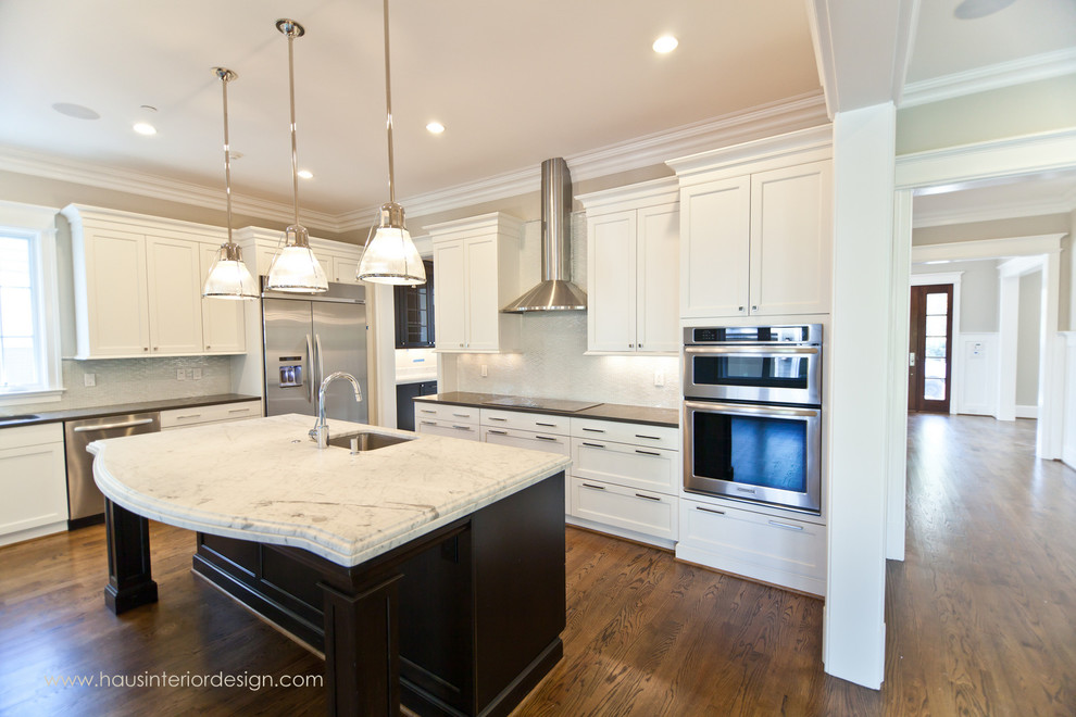 Example of a huge transitional single-wall medium tone wood floor open concept kitchen design in DC Metro with a double-bowl sink, shaker cabinets, white cabinets, white backsplash, glass tile backsplash, stainless steel appliances and an island