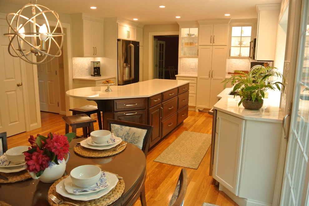 Example of a transitional medium tone wood floor eat-in kitchen design in Boston with an undermount sink, shaker cabinets, quartz countertops, beige backsplash, mosaic tile backsplash, stainless steel appliances, an island and white countertops