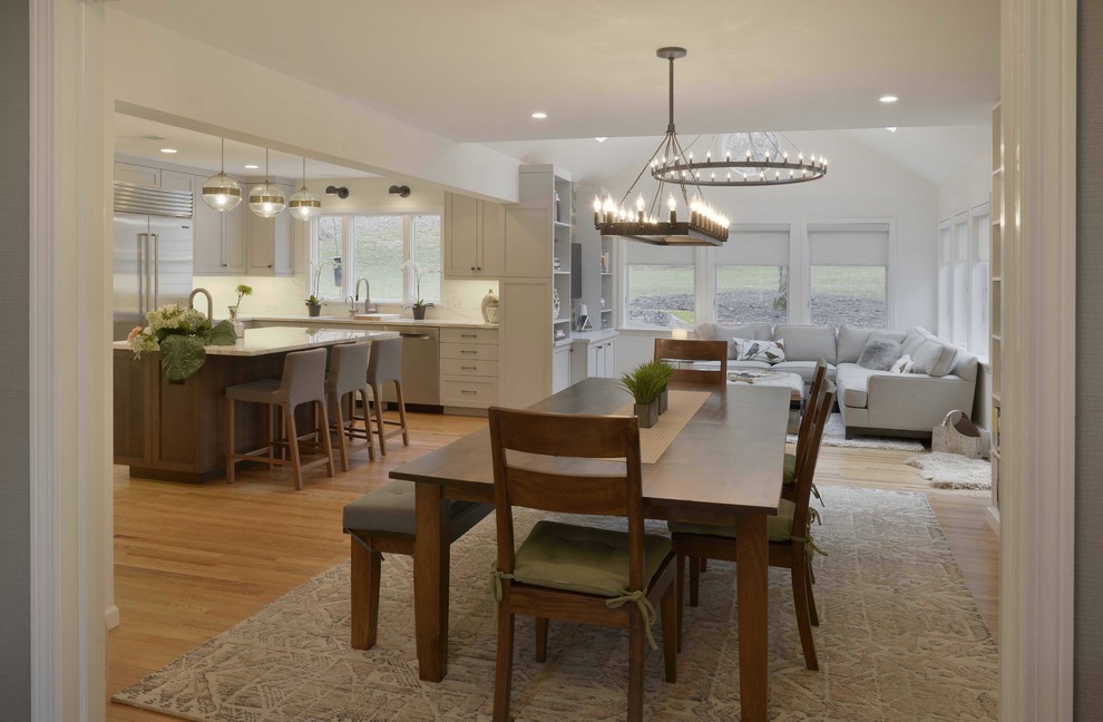 Mid-sized minimalist u-shaped light wood floor and brown floor eat-in kitchen photo in New York with an undermount sink, shaker cabinets, gray cabinets, tile countertops, white backsplash, porcelain backsplash, stainless steel appliances and an island
