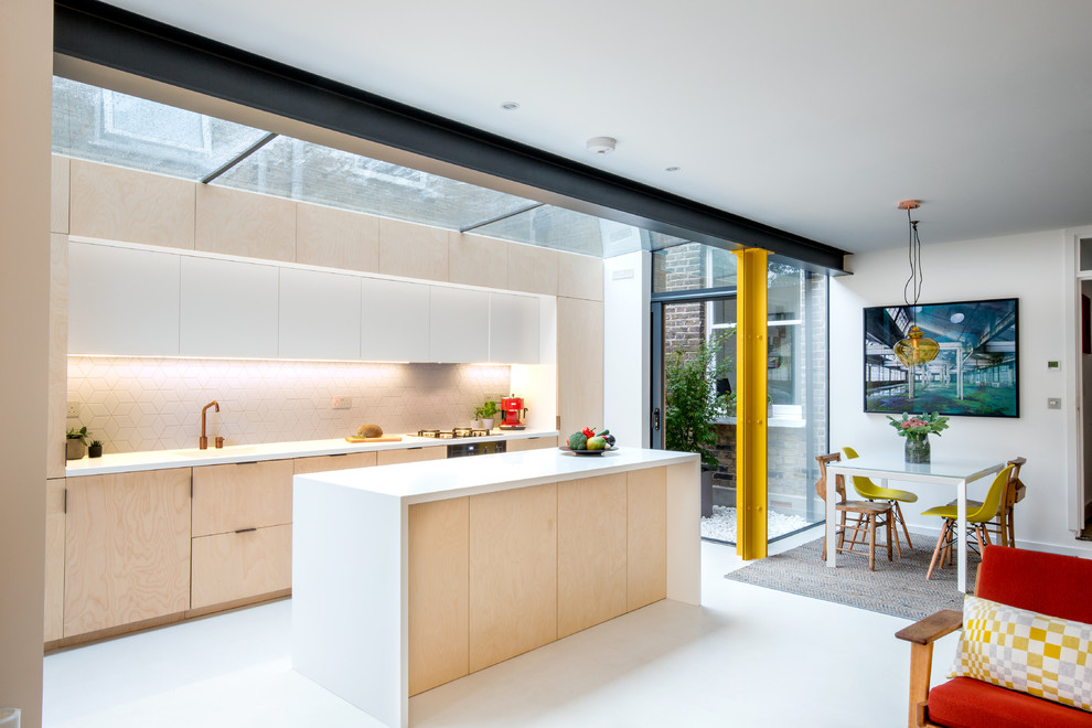 This is an example of a medium sized contemporary single-wall open plan kitchen in London with an integrated sink, flat-panel cabinets, light wood cabinets, white splashback, ceramic splashback, black appliances, concrete flooring, an island and white floors.