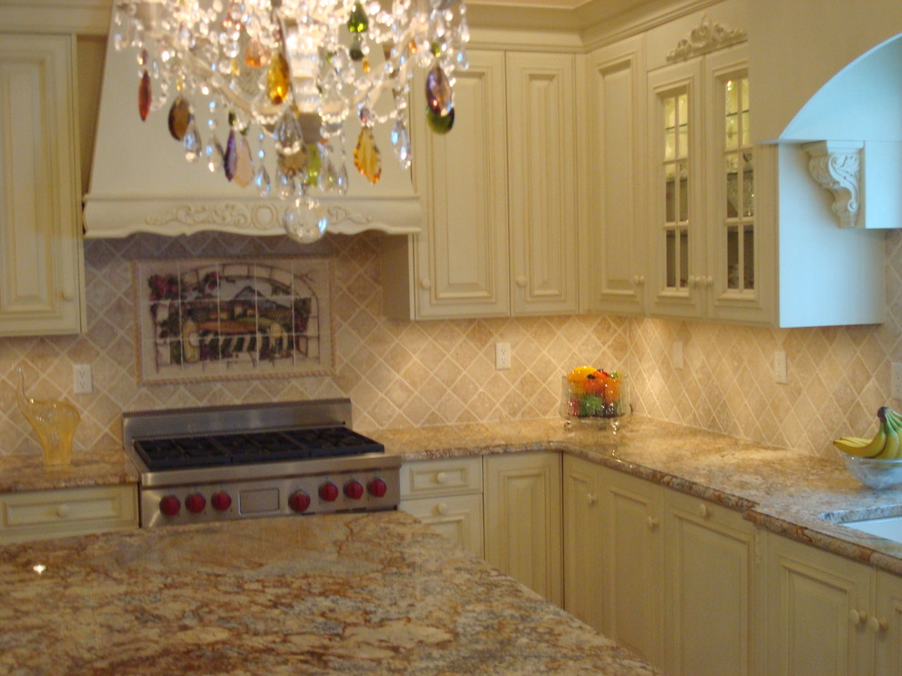 Photo of an expansive traditional kitchen in New York with raised-panel cabinets and white cabinets.