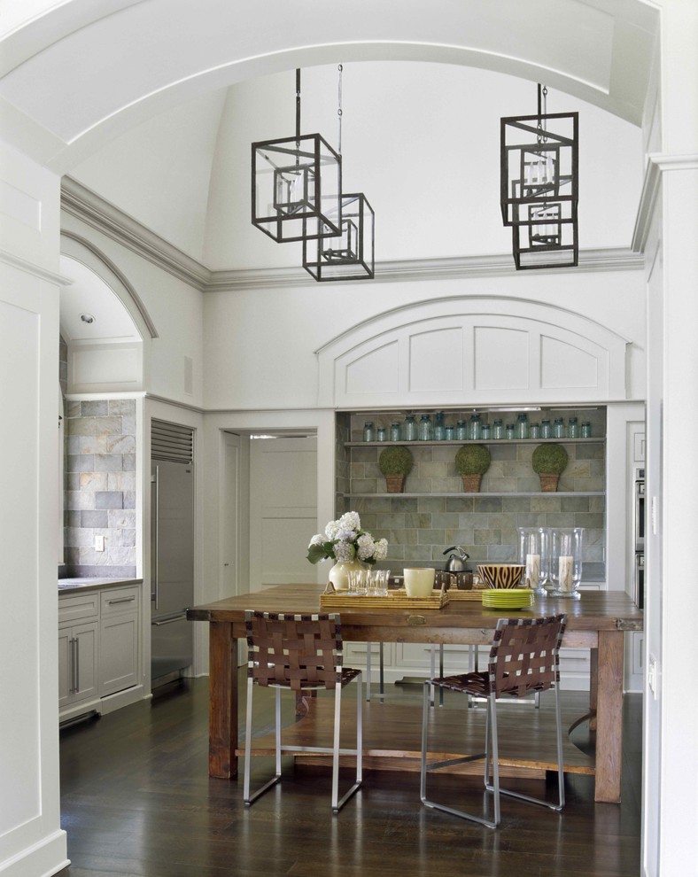 Classic kitchen in New York with stone tiled splashback and stainless steel appliances.