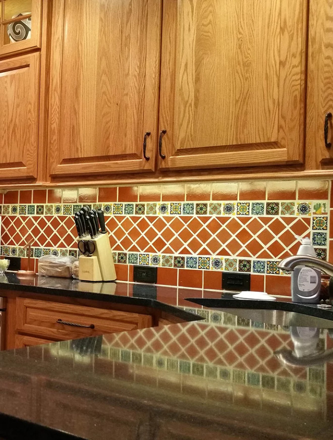 Kitchen - southwestern kitchen idea in Orange County with raised-panel cabinets, medium tone wood cabinets, quartz countertops, multicolored backsplash, mosaic tile backsplash and stainless steel appliances