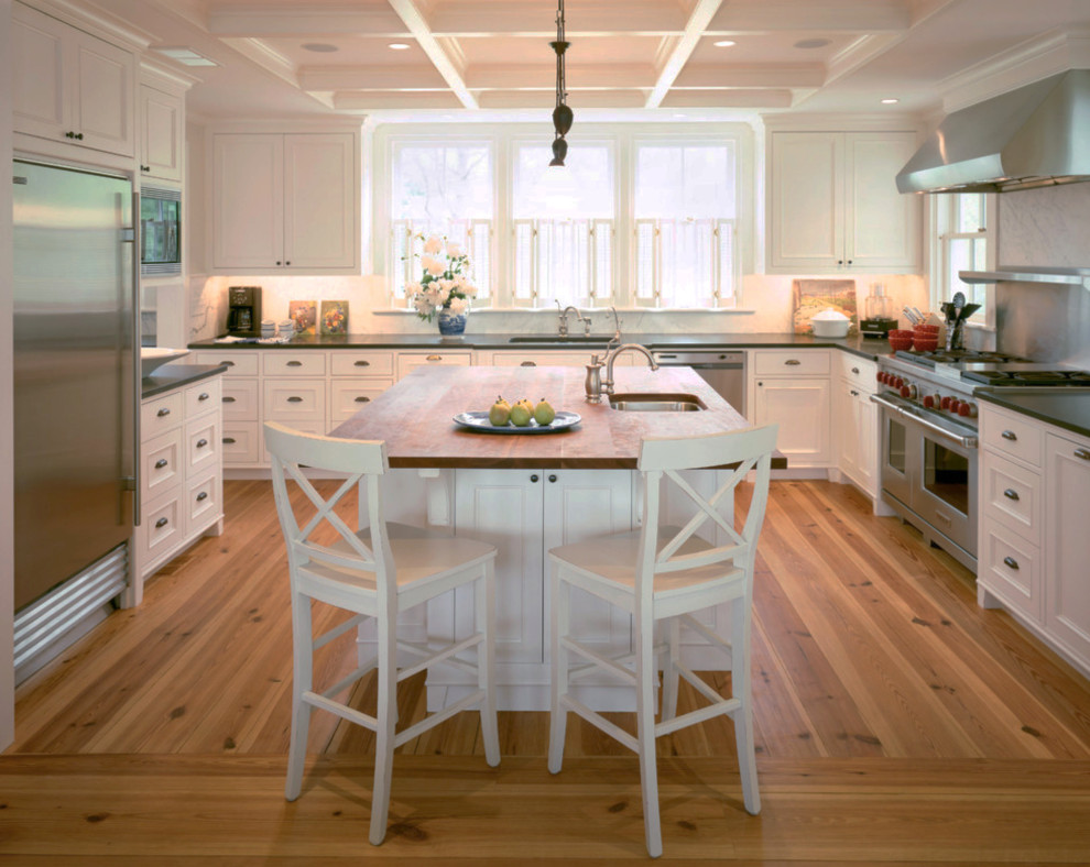 Design ideas for a medium sized l-shaped kitchen/diner with a single-bowl sink, recessed-panel cabinets, light wood cabinets, stainless steel appliances, an island, composite countertops, white splashback, light hardwood flooring, brown floors and green worktops.