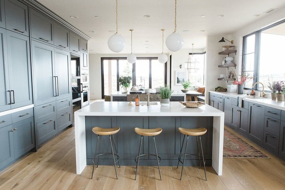 Example of a large eclectic medium tone wood floor open concept kitchen design in Salt Lake City with blue cabinets and two islands